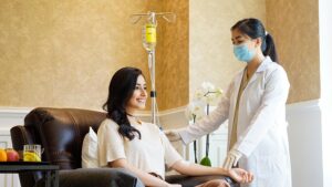 woman taking an iv and assisting by nurse